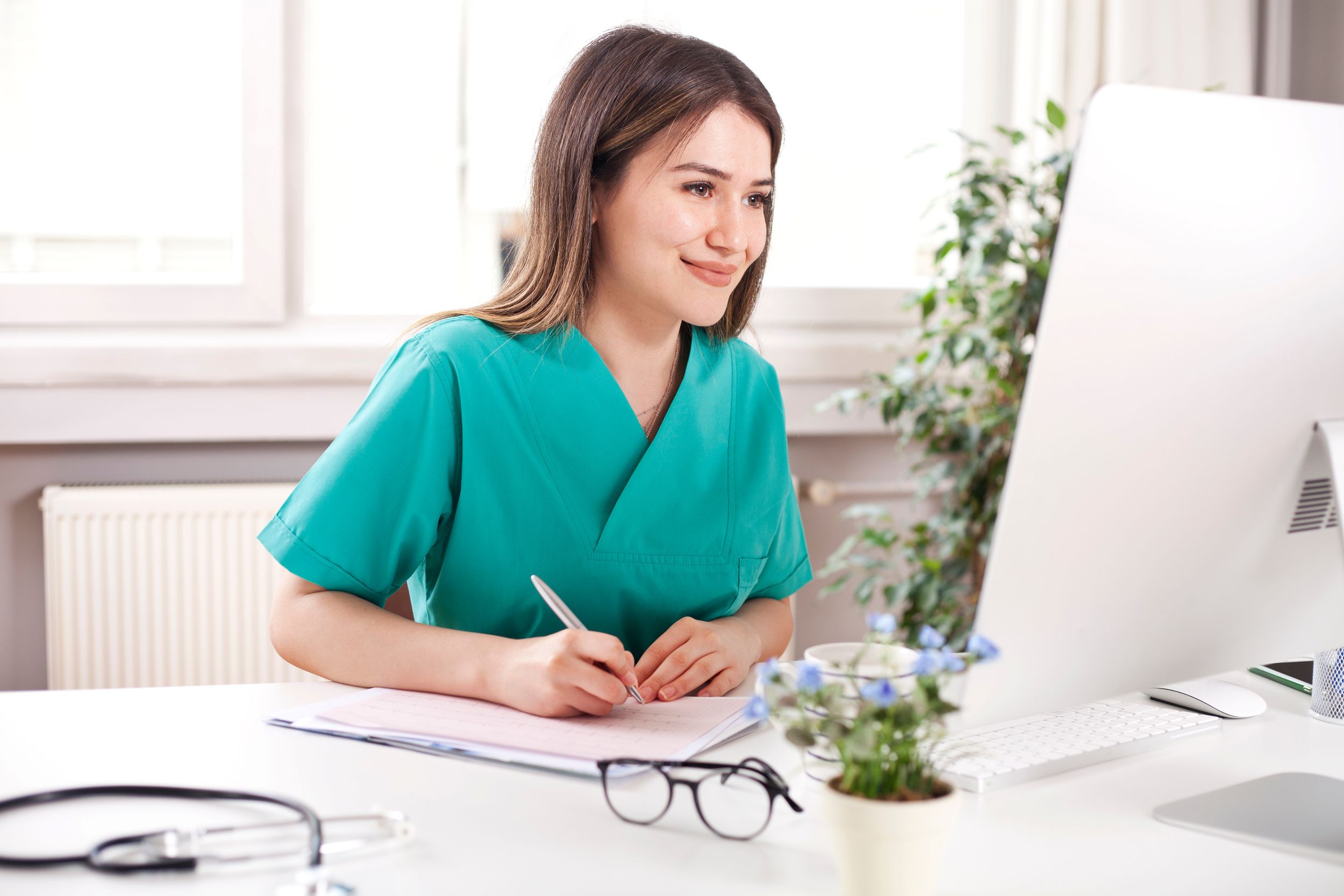 Care giver looking at data on computer sreen