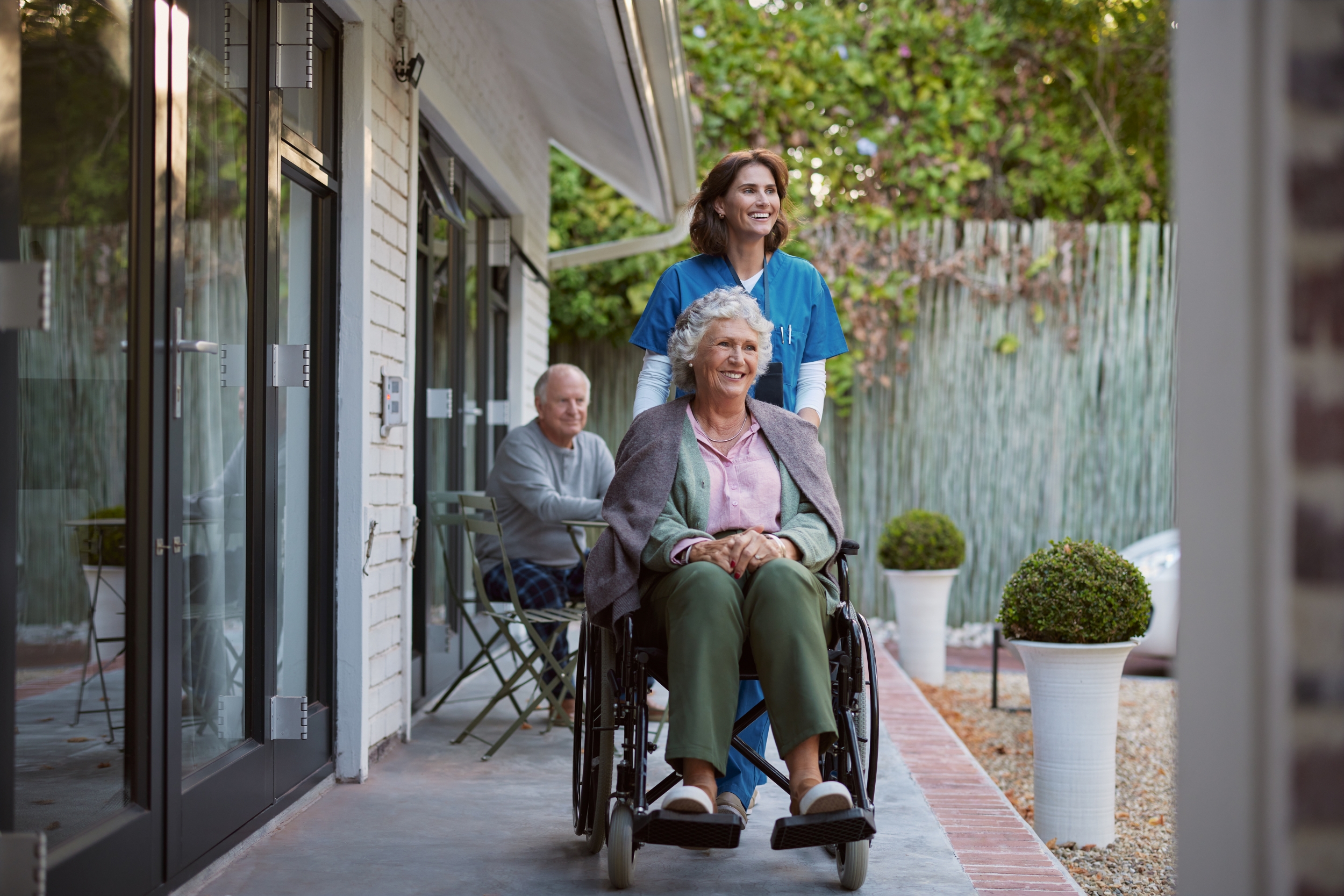image of a caregiver with a senior patient in a wheelchair